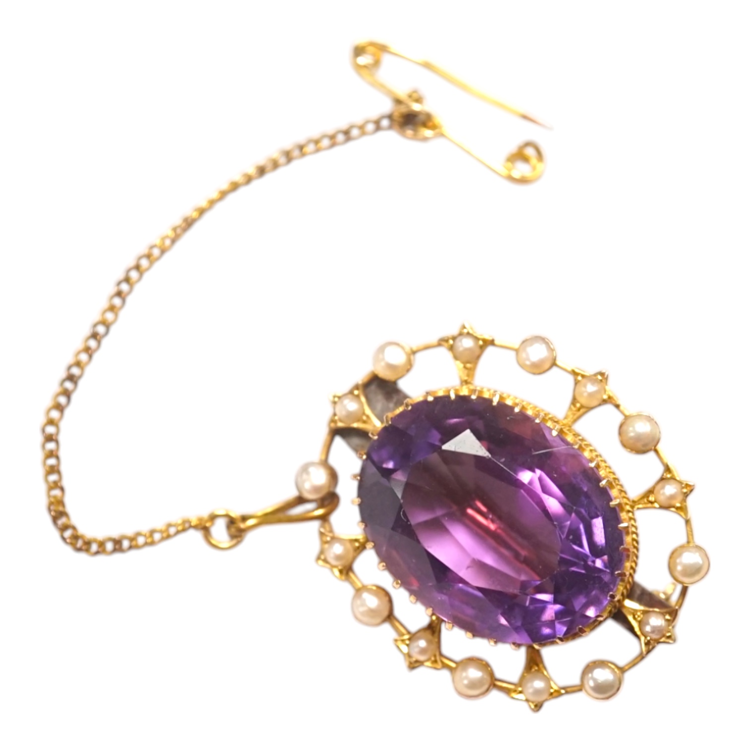 An Edwardian yellow metal, amethyst and split pearl set oval cluster brooch, 29mm, gross weight 7.2 grams. Condition - fair to good